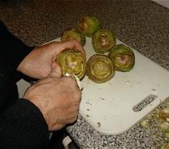 Step 5: The third part of preparing the artichokes is to remove the very fibrous small white leave…