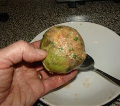 Step 8: Spoon the mixture into the empty heart of the artichoke.