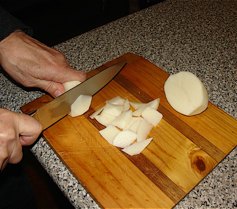 Step 4: Cut the potato into small pieces with a feathered edge and add them to the mix while simme…